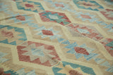 Abrashed geometric banded medallions with sky blue, cranberry, and beige kilim weave.