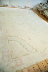 Corner of vintage Dhurrie rug showing pale peach and coffee brown geometric outlines.