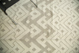 Hand woven Egyptian Kilim carpet showing abstract geometric ivory and grey pattern.