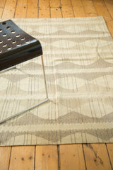 Hand-woven modern Kilim rug with ivory, beige, and grey alternating stripes and diamond pattern.