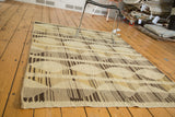 Egyptian Kilim rug with alternating ivory, mellow gold, grey, brown striped diamond pattern.