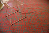Modern Turkish kilim carpet with black cherry red and charcoal 'endless knot' geometric pattern.