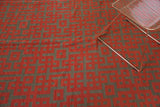 Modern Kilim carpet with repeating endless knot motif in black cherry red and dark charcoal.