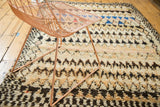 Plush ivory, charcoal, and blush pile with bold geometric patterns on a vintage Moroccan rug.