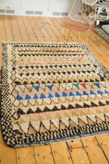 Dense speckled geometric border on a vintage Moroccan rug, highlighting plush pile texture.