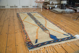 Vintage Moroccan runner, speckled blue-saffron yellow stripe, soft orange lattice design, plush pile.