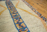 Plush ivory pile with vibrant speckled stripe and yellow geometric lattice on vintage Moroccan rug.