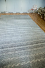 Vintage flatweave carpet showing speckled ground and varying platinum and silver stripes.