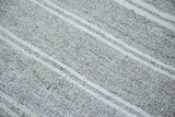 Speckled salt and pepper ground with white banded stripes on the vintage Turkish flatweave.