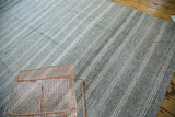 Varying thickness beige, platinum stripes and speckled salt and pepper ground on a vintage flatweave carpet.
