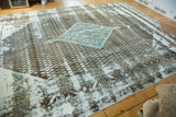 Distressed Serbend border, charcoal patterns, and exposed pale silver foundation on the Sivas rug.