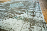 Decorative distressed texture of the Turkish carpet in charcoal, sky blue, and pale silver.