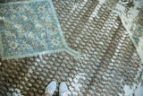 Distressed antique Sivas rug with faded sky blue medallion, charcoal pile, exposed foundation.