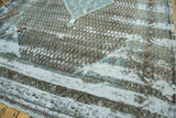 Distressed Sivas carpet: exposed white foundation, textured charcoal, and sky blue motifs.