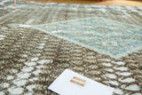 Textural detail of the Sivas carpet's distressed pile, revealing foundation and faded blue patterns.