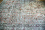 Vintage Tabriz rug's distressed blush red field, with muted tree motifs and patterned border.