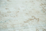 Distressed vintage Sparta carpet pile shows muted ivory, brown, and pale blue patterns.