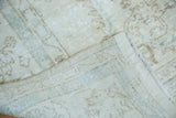 Vintage Sparta carpet's distressed pale ivory and blue allover pattern, revealing woven foundation.