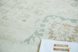 Hand-knotted vintage Sparta carpet close-up, showing splayed palmettes and textured pile distress.