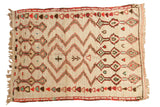 Vintage Moroccan rug with ivory field, symmetrical zig-zags and diamond patterns in red, green, brown.
