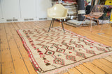 Plush pile vintage Moroccan rug with geometric zig-zag and diamond motifs in ivory, brick red, mint green.