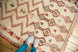 Plush hand knotted vintage Moroccan rug showcasing geometric zigzags in ivory, red, brown, and mint green.