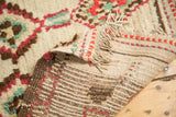 Plush ivory pile, fringed edge, and hand-knotted foundation details of a vintage Moroccan rug.