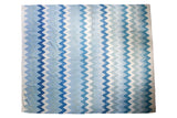 Egyptian Kilim carpet featuring repeating geometric zigzags in ivory, slate, and navy blue.