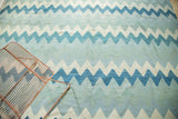 Repeating zigzag motif on hand woven Egyptian Kilim in slate blue, navy, and ivory tones.