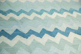Hand-woven Egyptian Kilim detail featuring zigzag mountain pattern in blue and ivory.