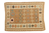 Vintage Turkish Kilim rug featuring geometric diamond rows in bronze, aqua, mint, and ivory.