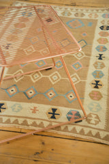 Pastel geometric diamonds and main border patterns on this vintage Turkish Kilim rug.
