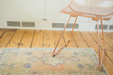 Soft, faded vintage Turkish Oushak rug runner with peach, blue floral diamond motifs.
