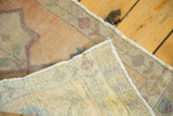 Faded peach pile, woven foundation, and secured edge of a vintage Oushak runner.