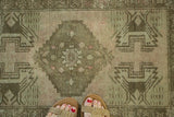Vintage Oushak runner showcasing stepped medallion, floral motif, and textured blush distress.