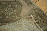 Vintage Oushak rug corner showing faded blush pattern and tight hand-knotted foundation.