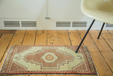 Hand knotted Vintage Oushak runner end, showing floral border and stepped geometric designs.
