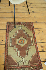 Stepped geometric medallion with zig-zag side border and floral end on vintage Oushak runner.