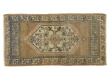 Vintage Distressed Oushak runner with hexagonal medallion, floral border in soft earth tones. 1'8