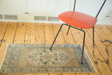 Vintage distressed Oushak runner with muted beige and subtle blue hexagonal design.