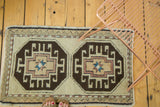 Geometric crab medallion on the vintage Oushak rug with star motif in charcoal, beige, and copper.