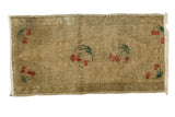 Vintage Oushak runner with scattered cherry motifs on a textured bronze-beige field.