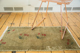 Vintage Oushak runner detail: hand-knotted bronze green pile, cherry motif, and fringe.