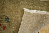 Hand-knotted back and fringe of Oushak rug, with bronze-green pile showing red cherry.