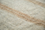 Hand woven texture of the modern Turkish Kilim rug with light grey, bronze, and charcoal stripes.