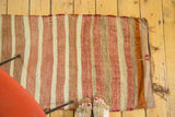 Vintage Turkish Kilim rug with blush, ivory, bronze stripes and tattered end.