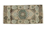 Vintage Oushak runner with ornate faded peach medallion, seafoam green, brown motifs, 1'6