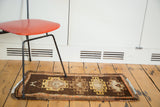 Geometric brown, saffron yellow, and tangerine orange stylized medallions on this Vintage Oushak runner.