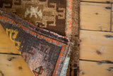 Visible hand-knotted construction and secured edge of vintage Oushak runner.