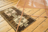 Vintage Oushak mat showcasing geometric double medallions with arrows in blush, ivory, and brown.